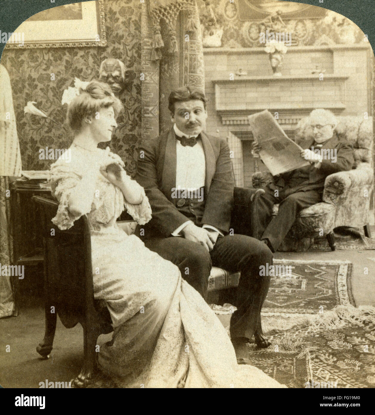 COUPLE, 1902. /n'Confronted by two prodigious tasks - to 'Pop the Question' and to 'Question the Pop.' Stereograph, American, 1902. Stock Photo