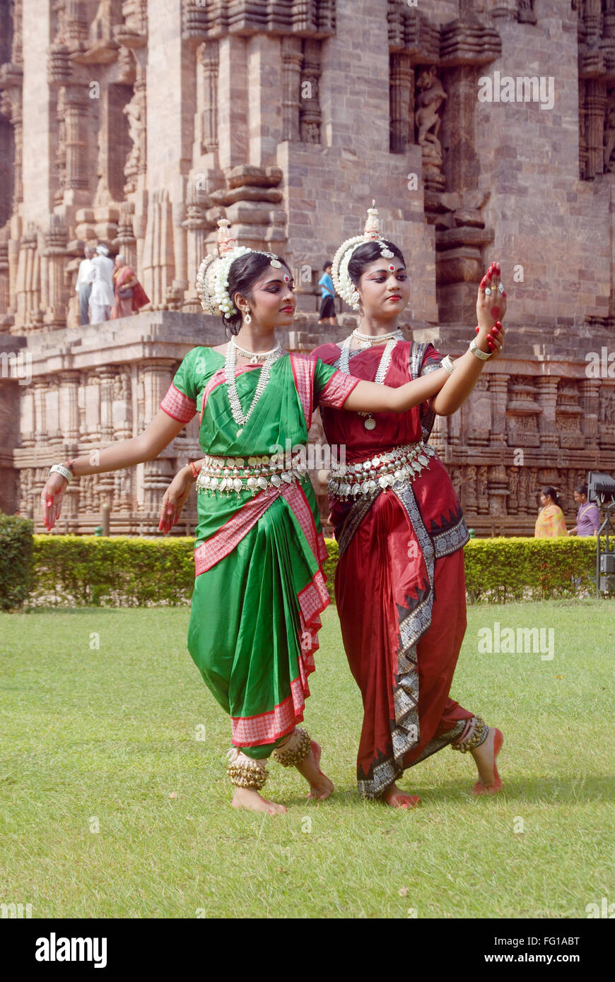 Dancers performing classical traditional odissi dance on lawn MR 736C