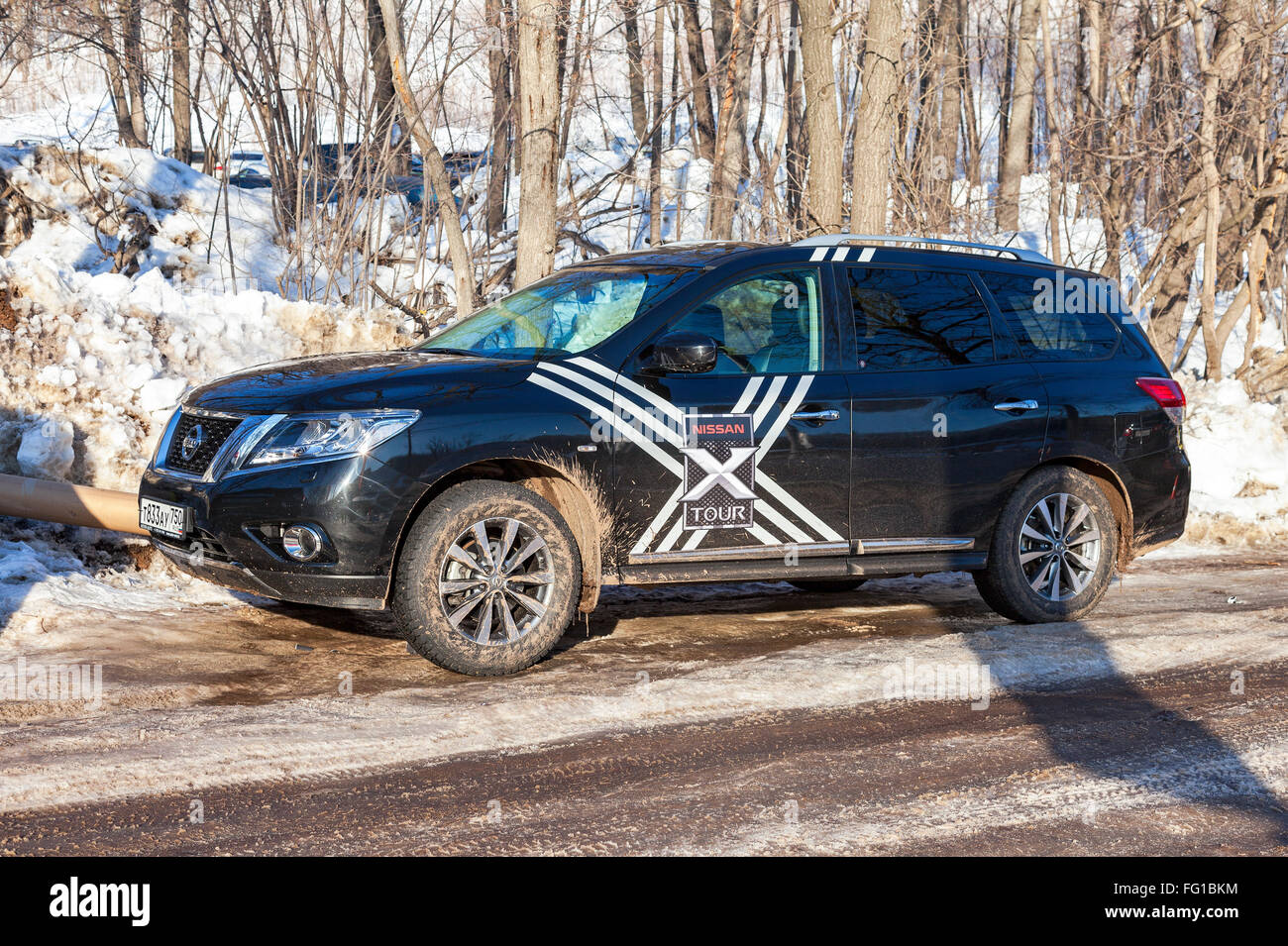 Vehicle Nissan Pathfinder parked up in sunny day on the rural road Stock Photo