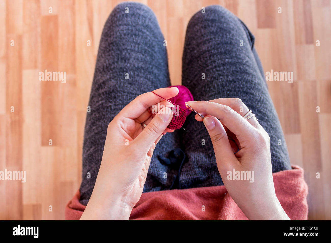 Girl making crochet circles for jewelry elements Stock Photo
