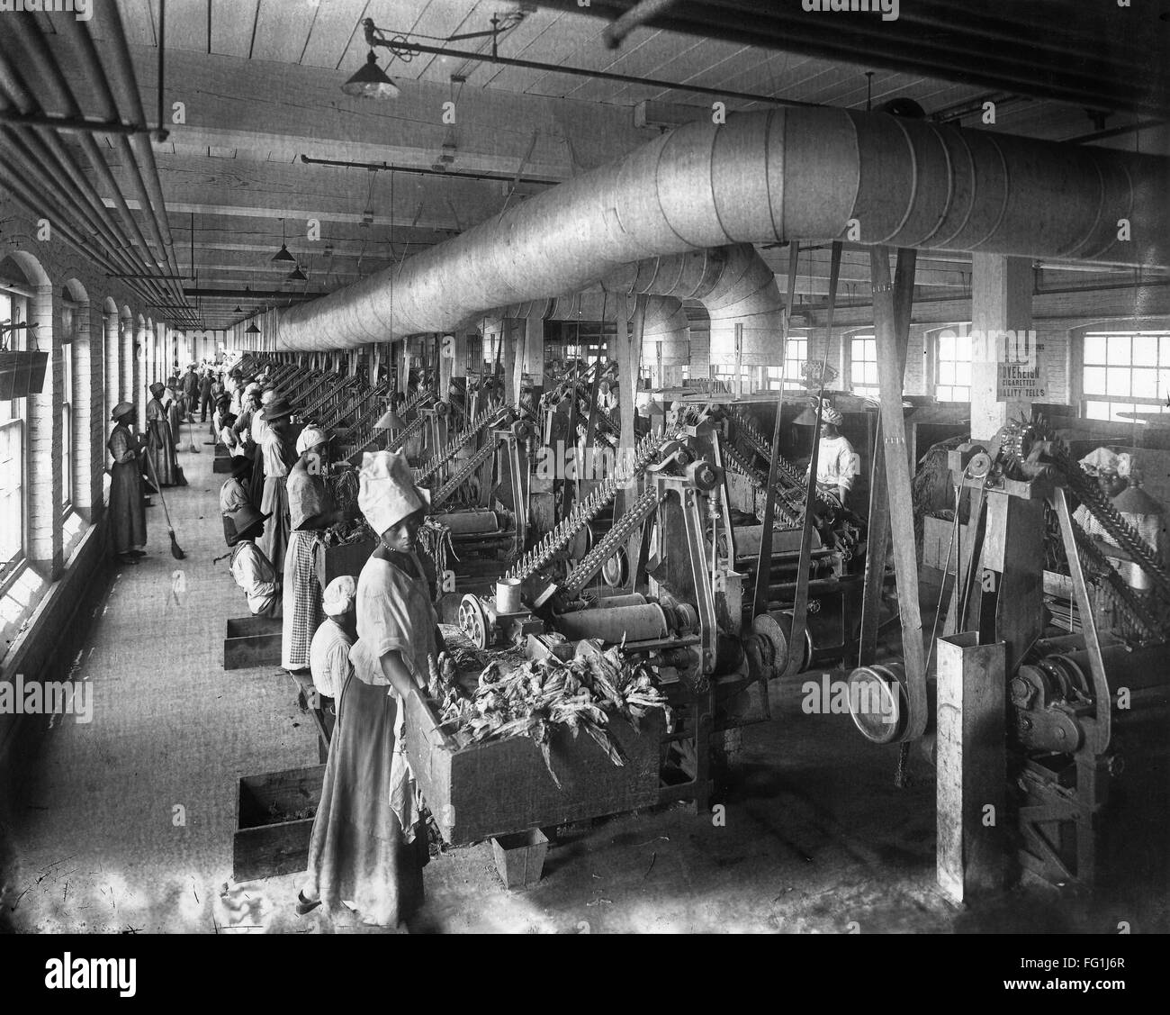 TOBACCO FACTORY, c1910. /nWomen working at stemming machines in an ...