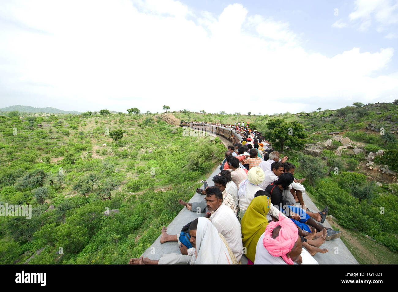 People sitting on train roof ; Rajasthan ; India NOMR Stock Photo