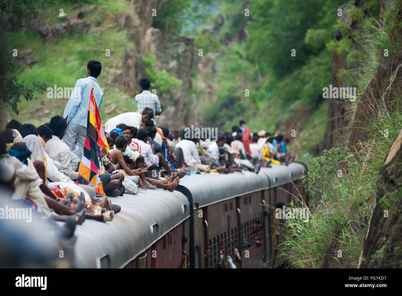 People sitting on train roof ; Rajasthan ; India Stock Photo