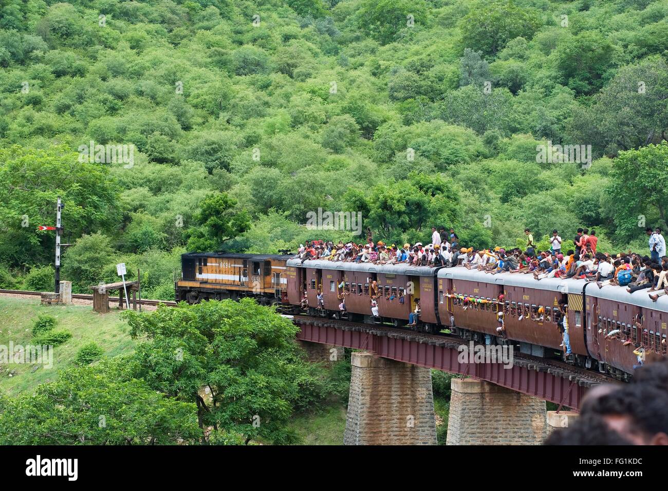 People sitting on train roof Marwar Jodhpur Rajasthan India Stock Photo