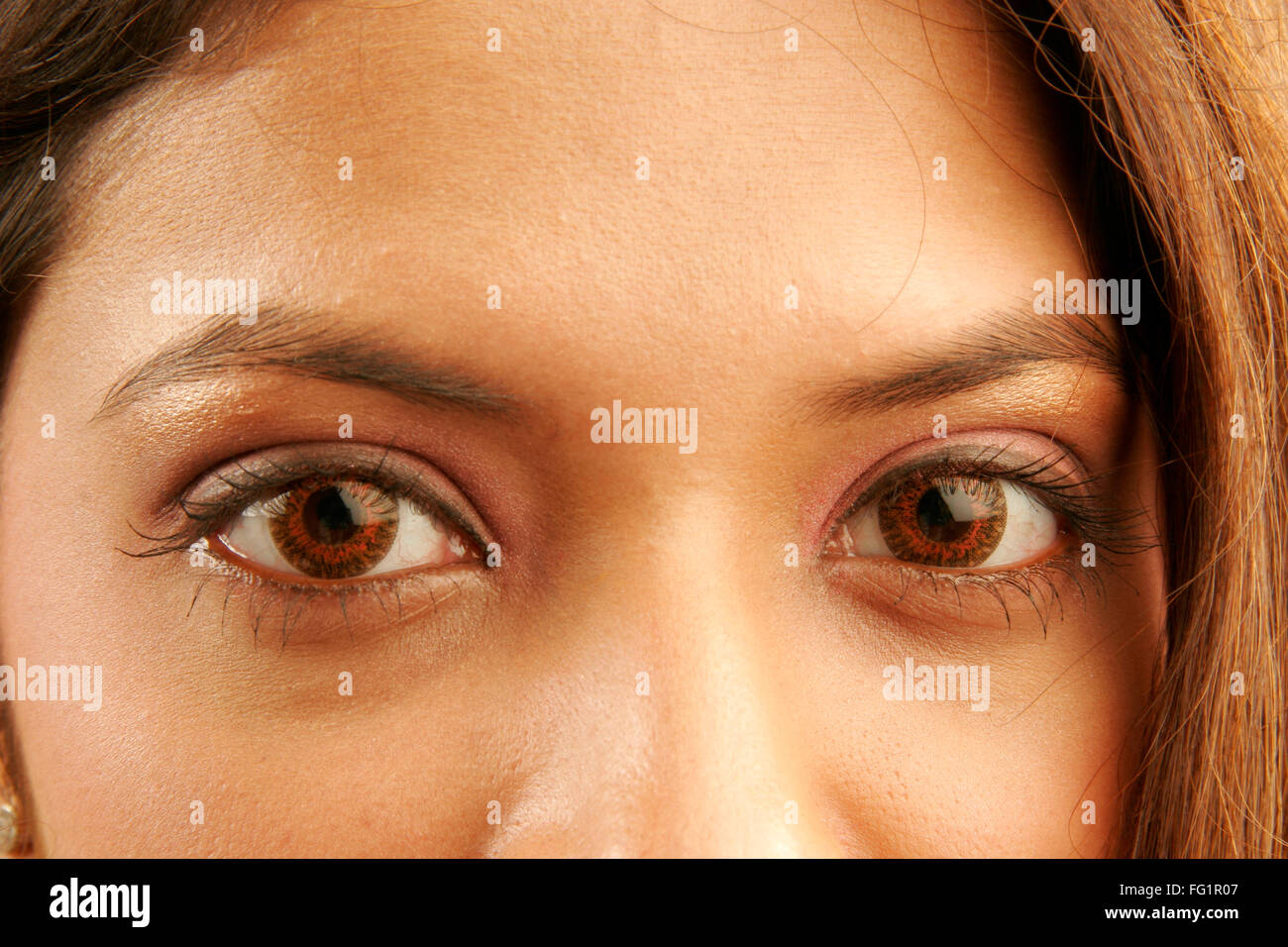 South Asian Indian teenager girl using red colour contact lenses in