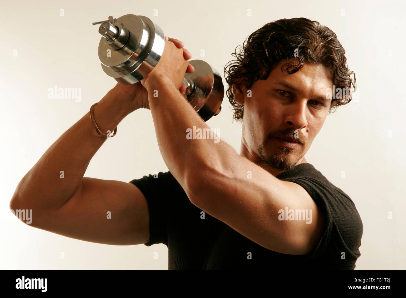 South Asian Indian Man Wearing Black T Shirt And Curly Oily Hair