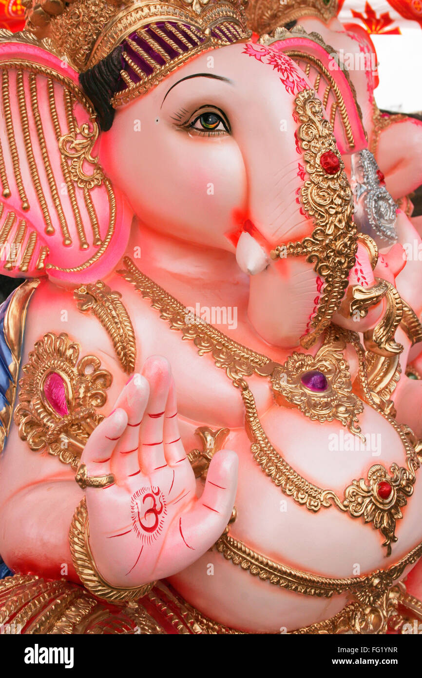 Idol of lord ganesha elephant headed god with om meaning welcome painted on right palm , Pune , Maharashtra , India Stock Photo