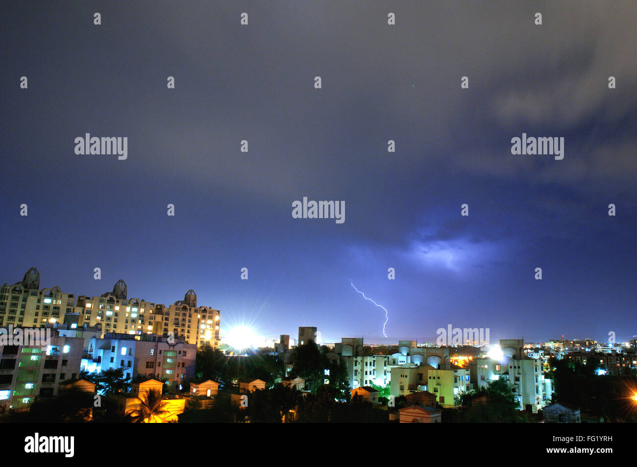 Cityscape lit up by lightning in night Pune ; Maharashtra ; India 9 April 2008 Stock Photo