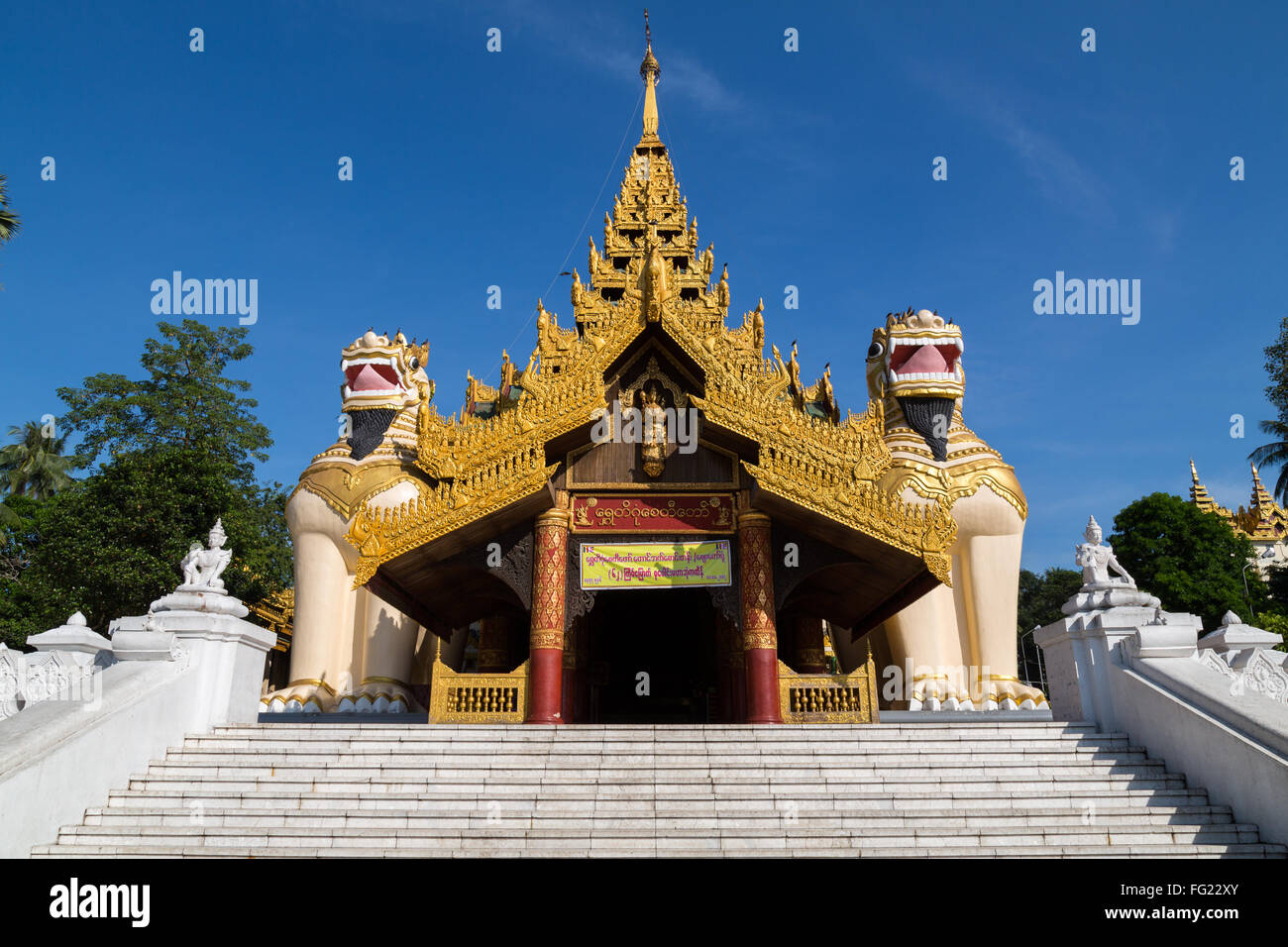 Entrance to the Shwedagon pagoda, guarded by two Chinthe Stock Photo