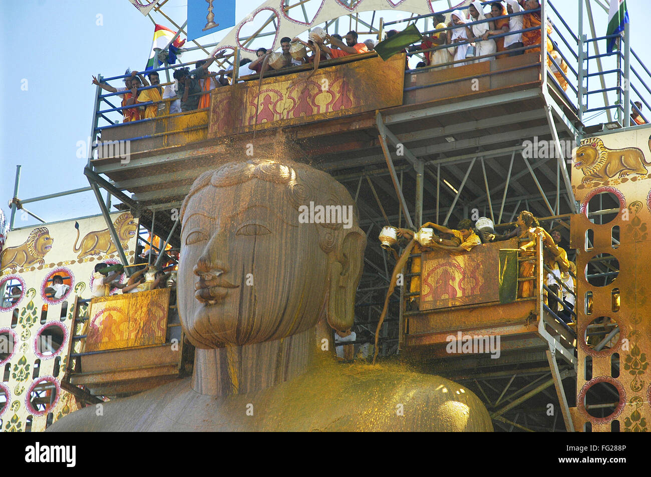 Jain Devotees Pouring Turmeric Water forehead monolithic Statue Gomateshwara Mahamastakabhisheka Shravanbelagola Karnataka Stock Photo