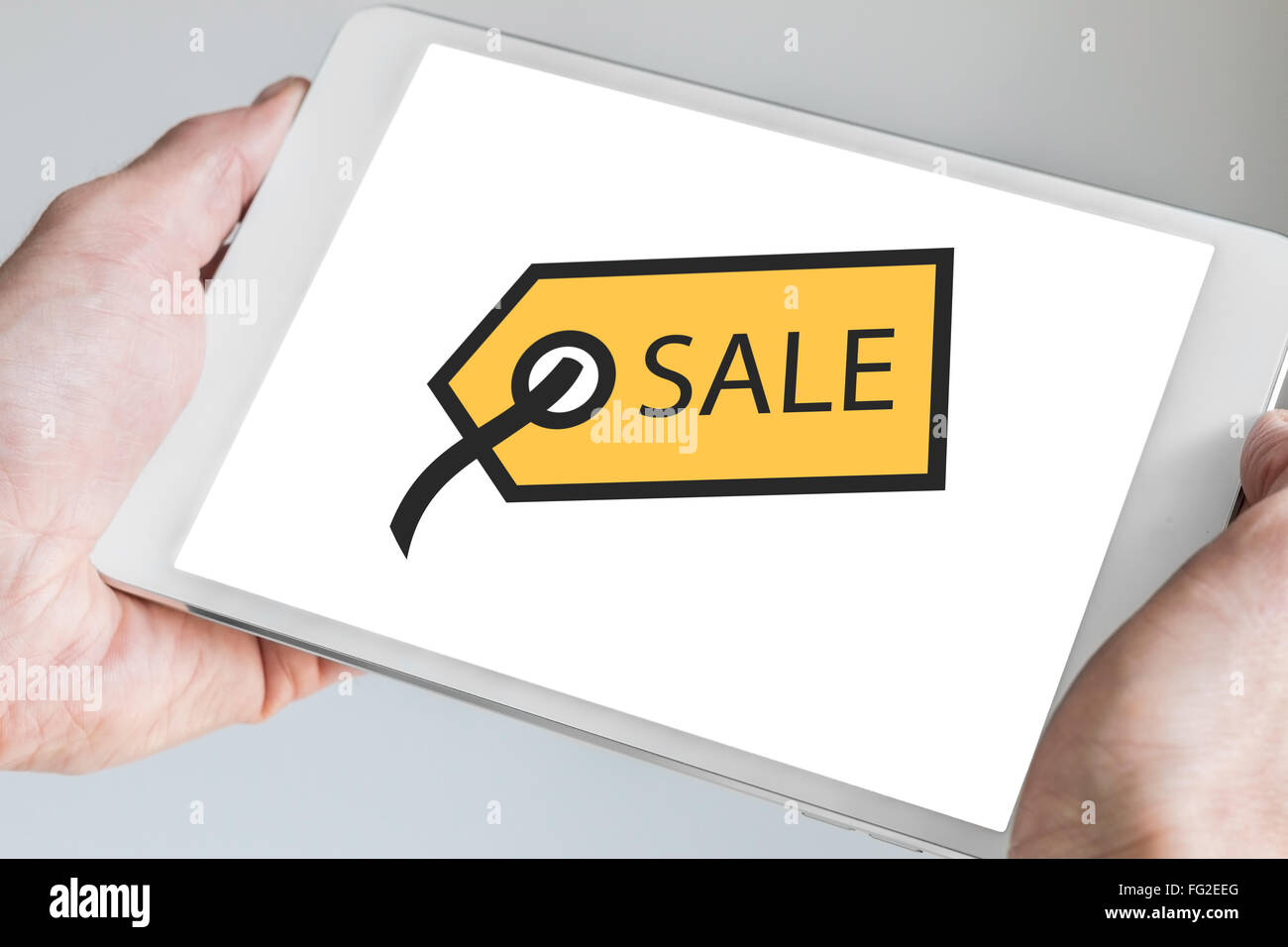 Sales tag symbol displayed on touchscreen of modern mobile device like tablet. Concept for mobile shopping and digital marketing Stock Photo