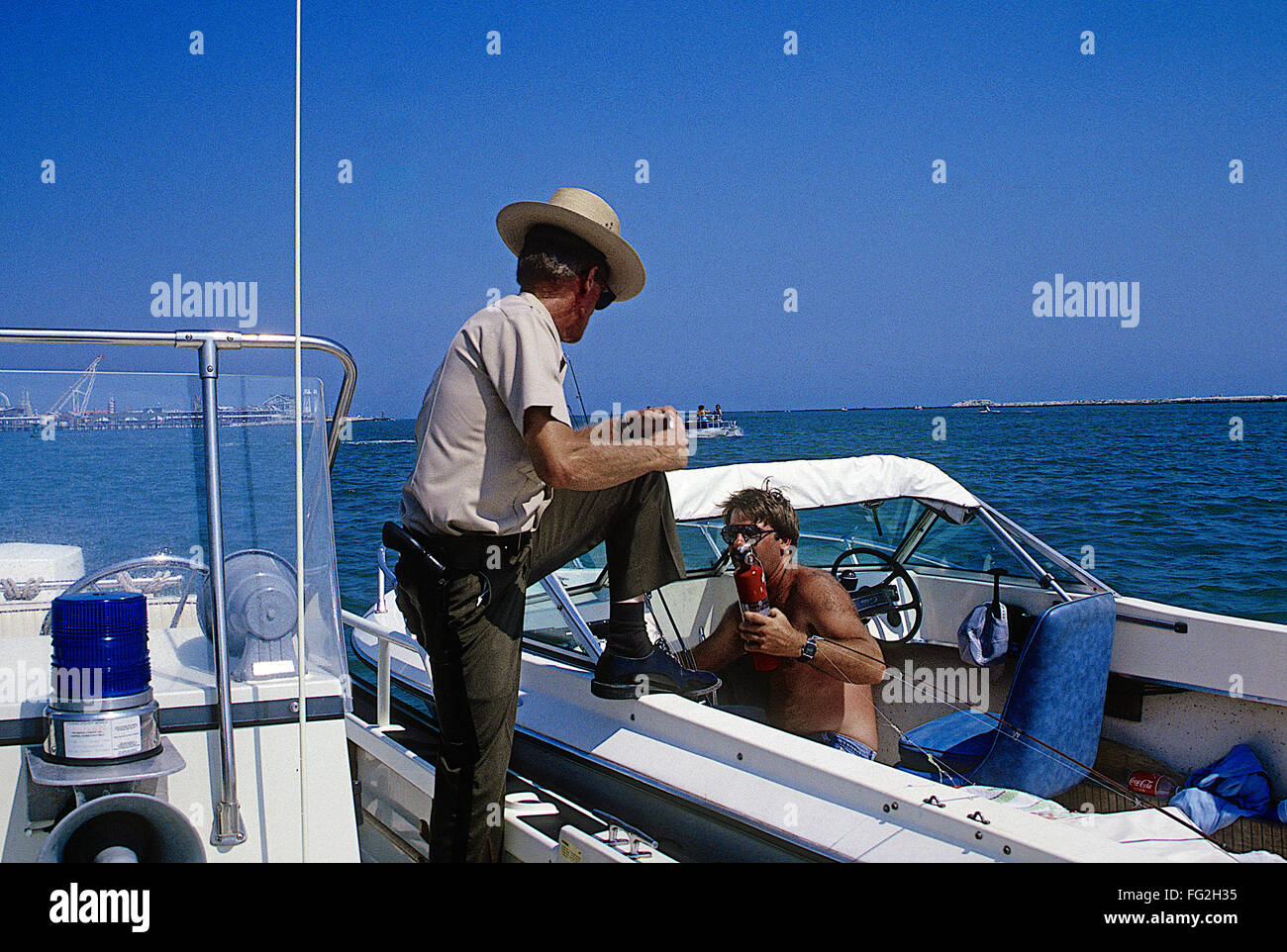 Ocean City, Maryland, USA, 23rd, July 1987 Officer Norman Mills of the Maryland Natural Resources marine unit conducts safe boating inspections while patrolling the waters of the Isle of Wight Bay on the west side of Ocean City Md.  Credit: Mark Reinstein Stock Photo