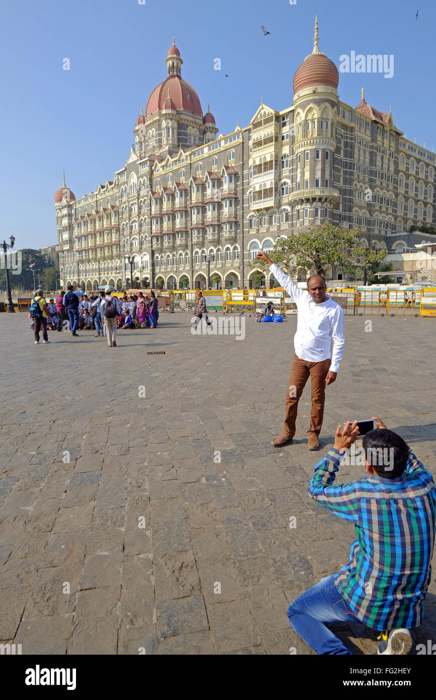 Indian tourists outside The Taj Mahal Palace Hotel, Mumbai, India Stock Photo