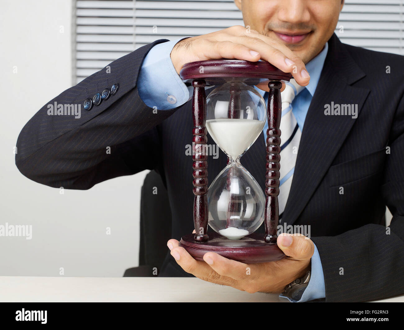 Executive holding sand clock MR#779K Stock Photo