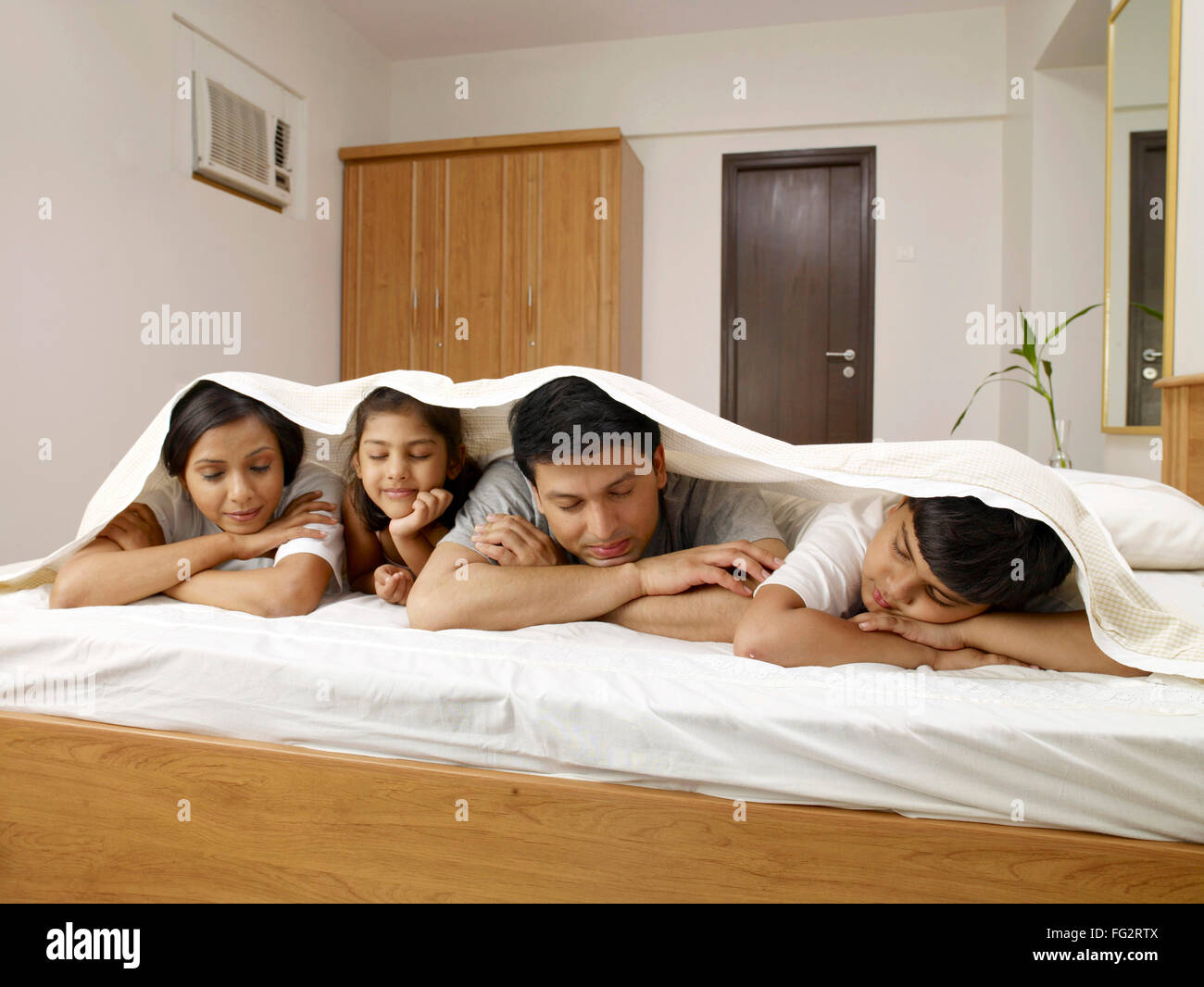 Parents with children under bed sheet sleeping on bed in bedroom MR702R,MR702S,MR702T,MR702U