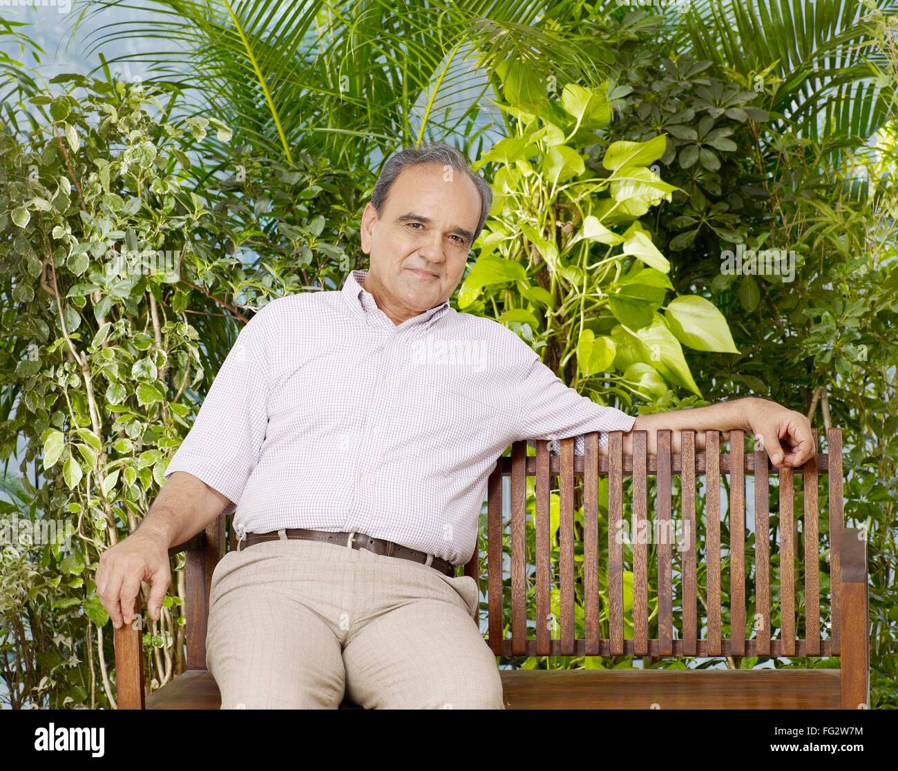 Old man sitting on wooden bench MR#702T Stock Photo - Alamy
