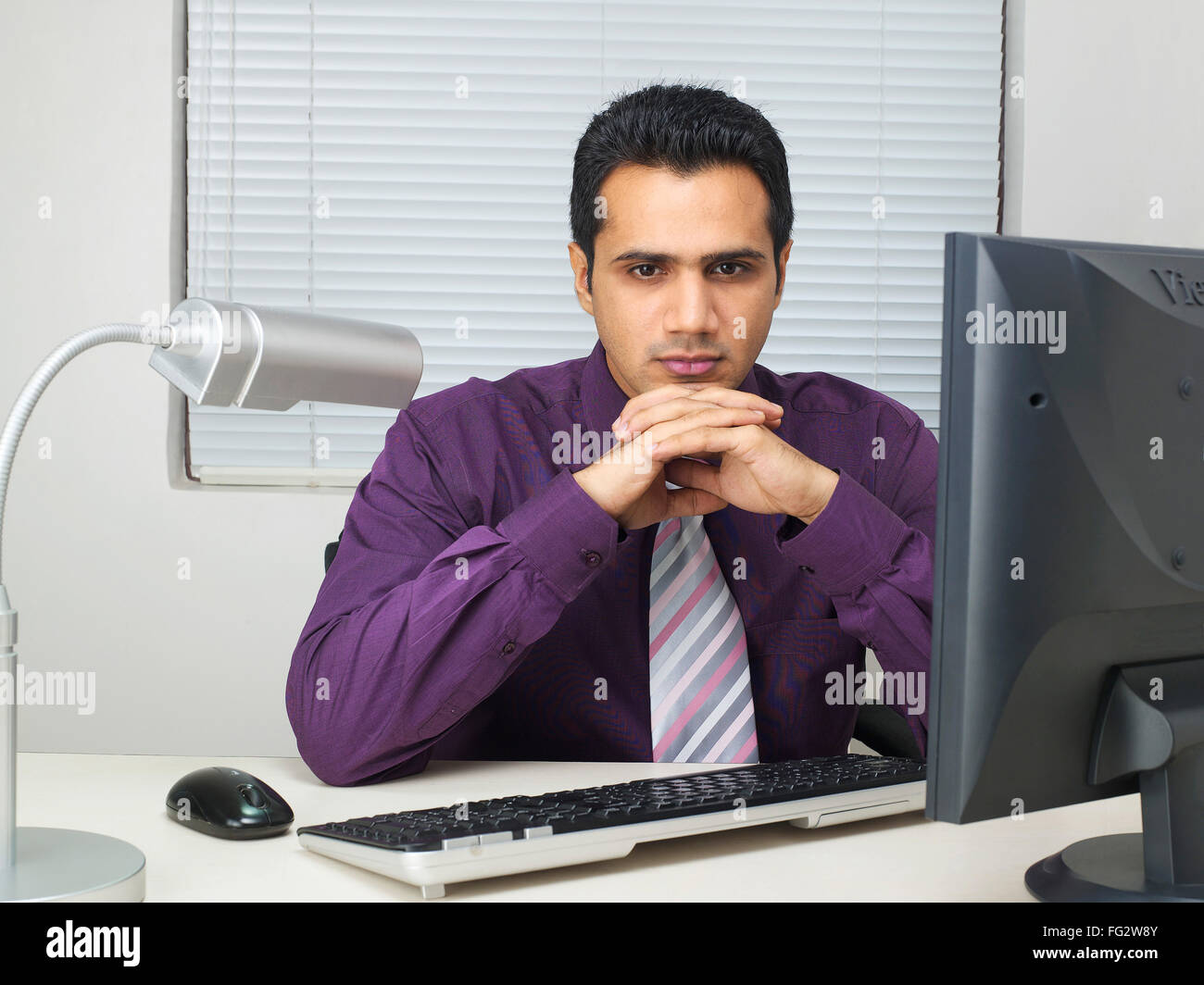 Executive holding hands on chin MR#779K Stock Photo