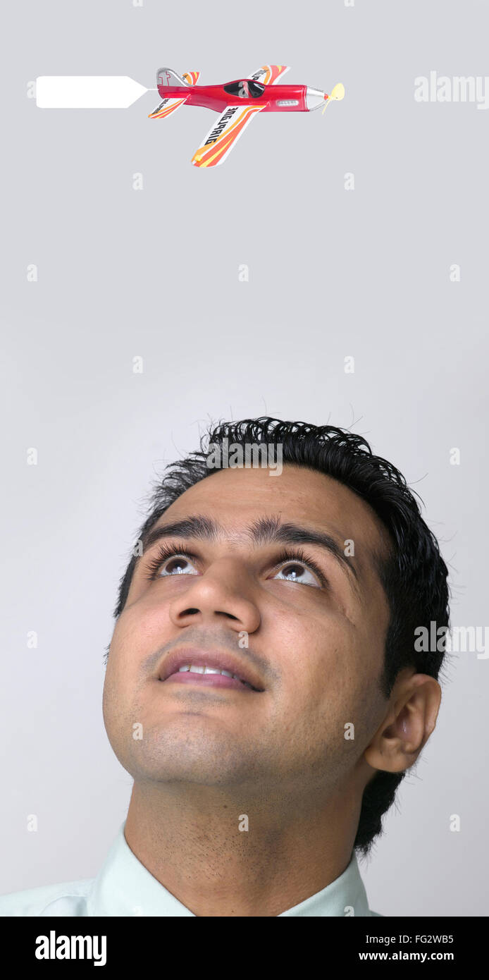 Executive looking at toy plane MR#779K Stock Photo