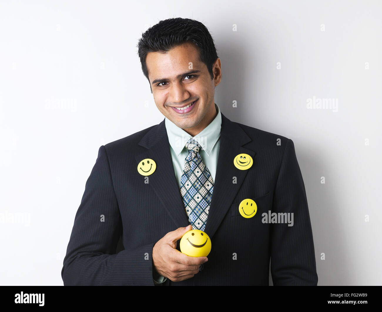 Smiley brooch on coat of executive showing smiley ball MR#779K Stock Photo