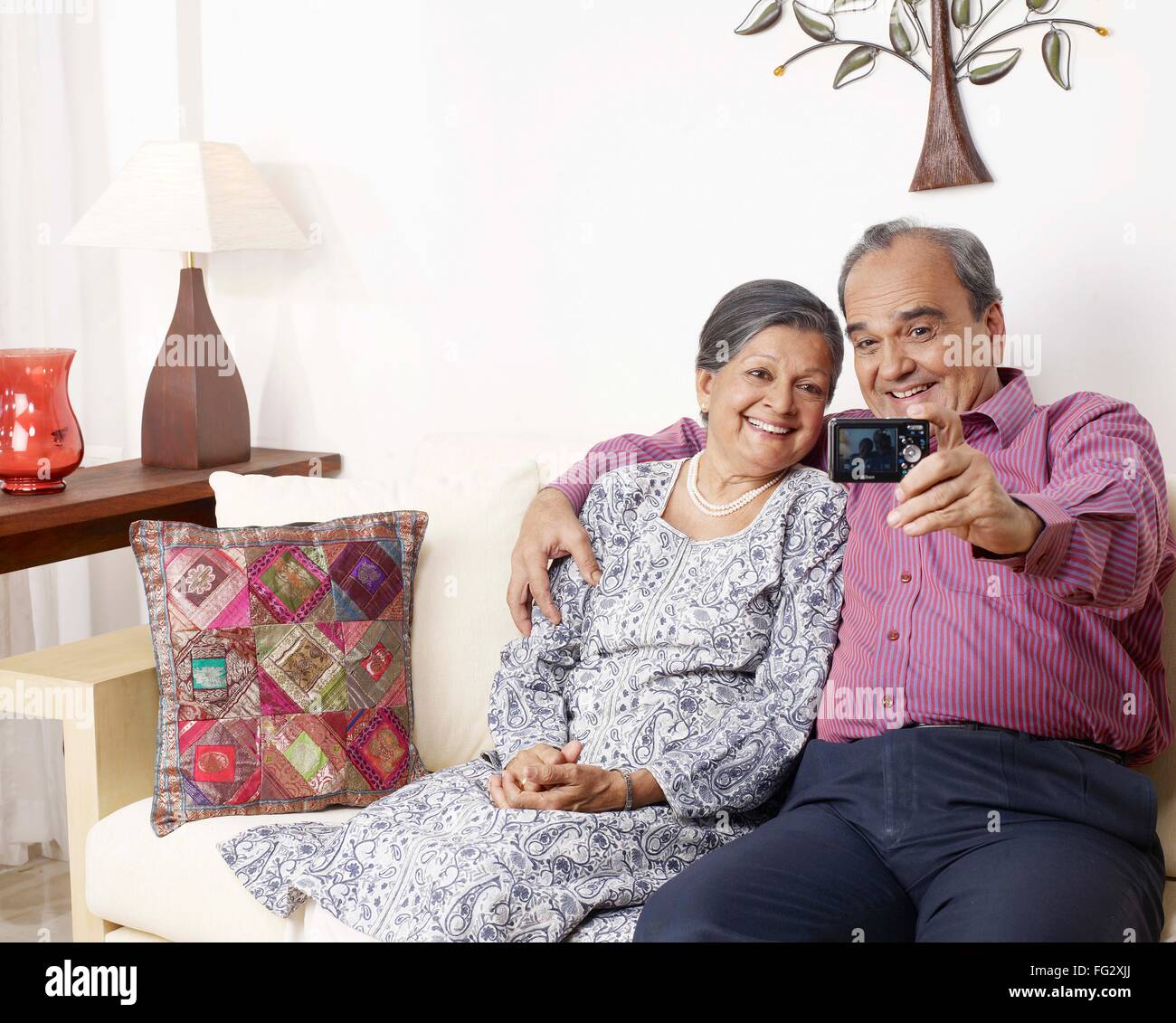 Old couple recording movement in digital camera MR#702T,702S Stock Photo