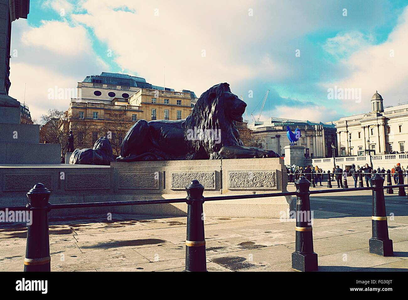 Lion Statues At Trafalgar Square Against Cloudy Sky Stock Photo Alamy