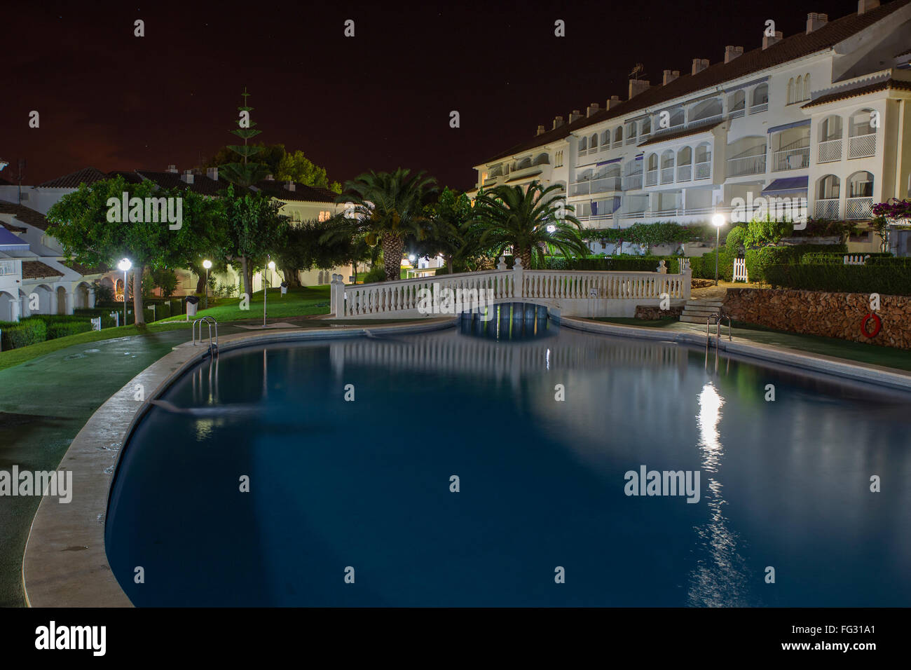Evening view for buildings behind swimming pool in night illumination ...
