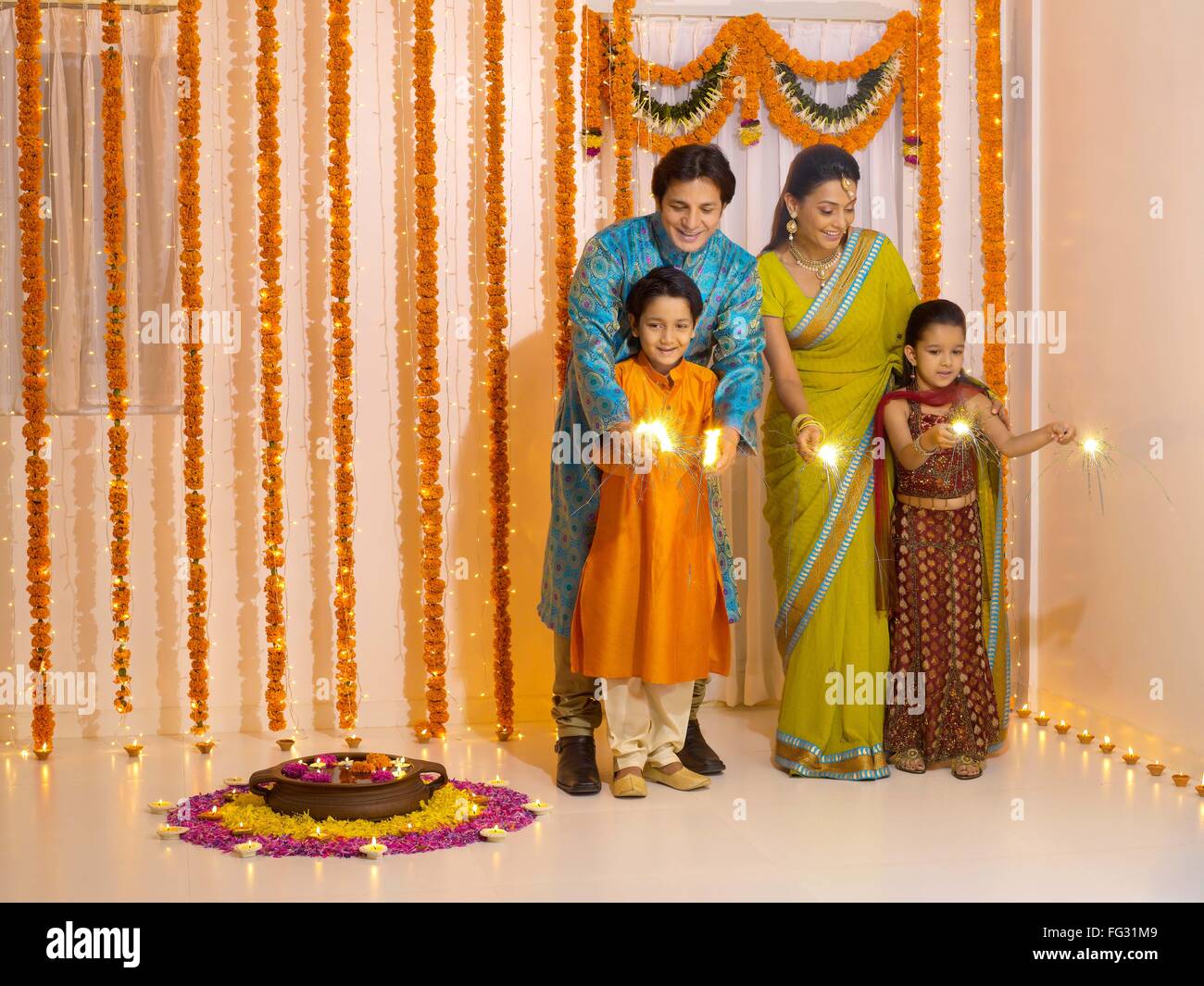 Indian family celebrating Diwali festival of lights India - model released MR#779P, MR#779Q, MR#779R, MR#779S Stock Photo