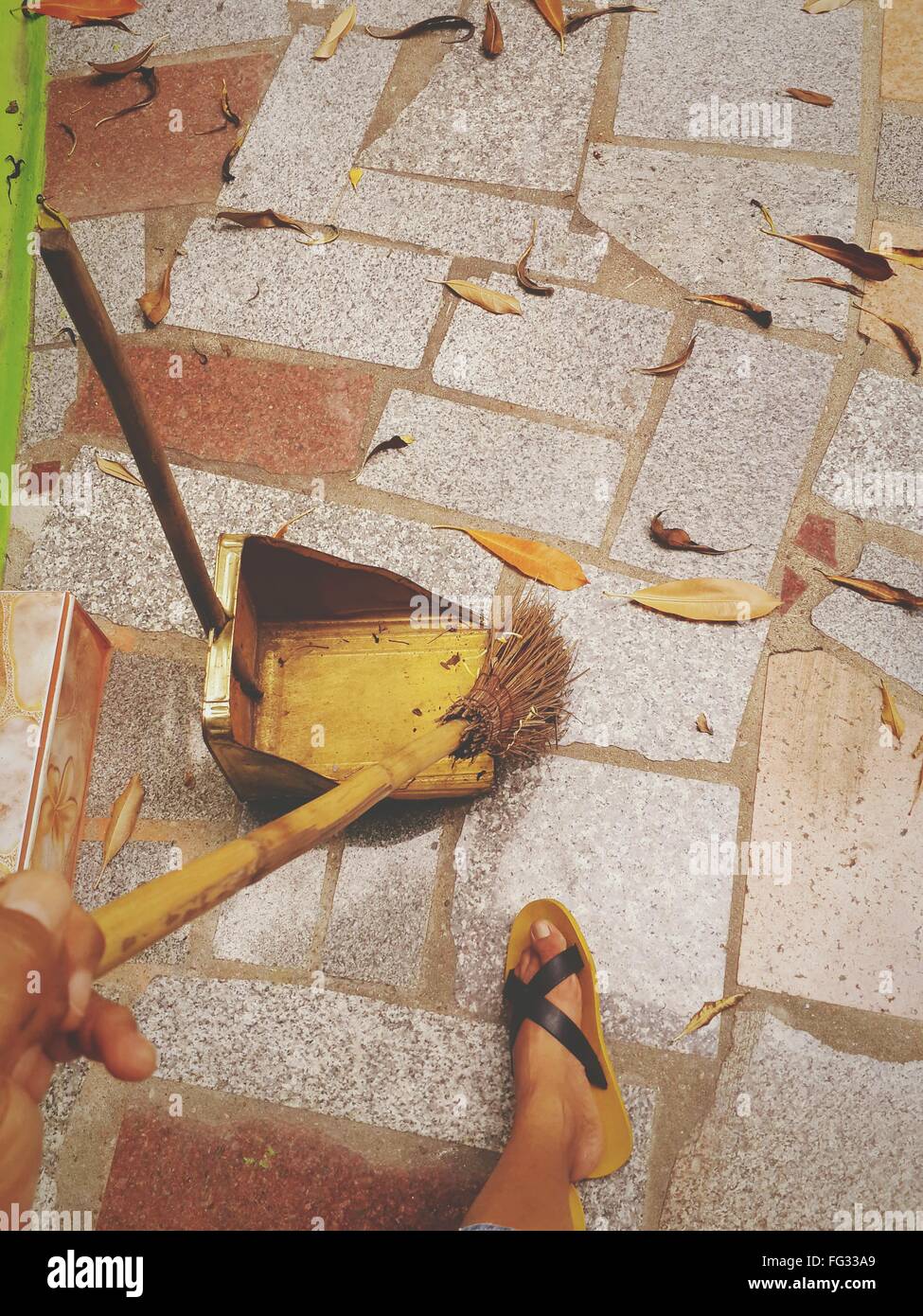 Low Section Of Person Sweeping Leaves In Yard Stock Photo Alamy