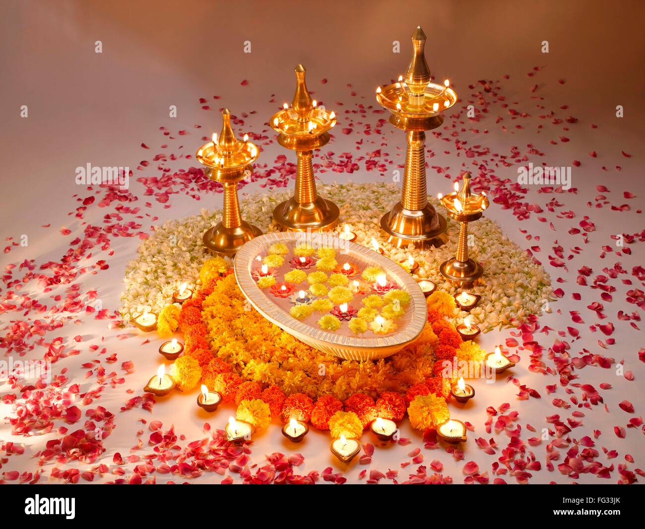 Diyas oil lamps and flowers arrangement for diwali festival ; India Stock Photo