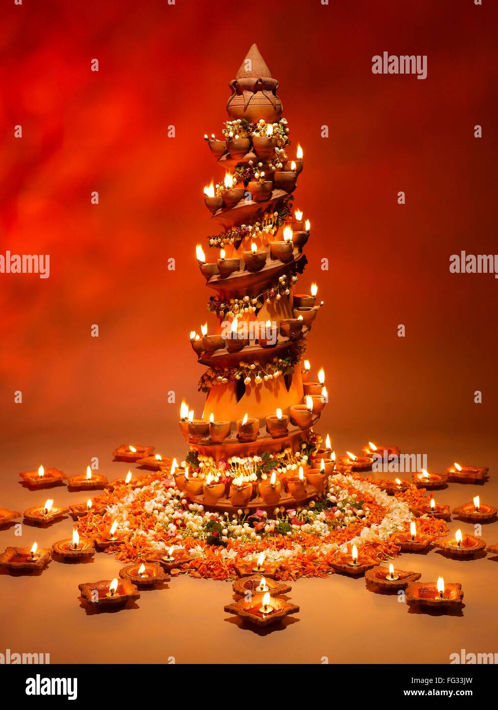 Diyas and flowers arrangement for diwali festival ; India Stock Photo