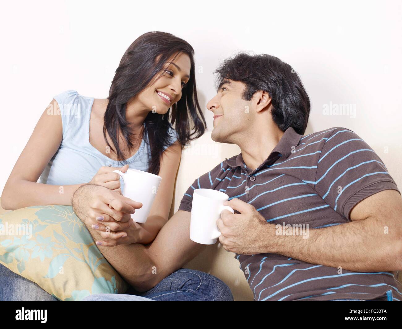 Young man and woman holding hands looking at each other MR#702V,702U Stock Photo