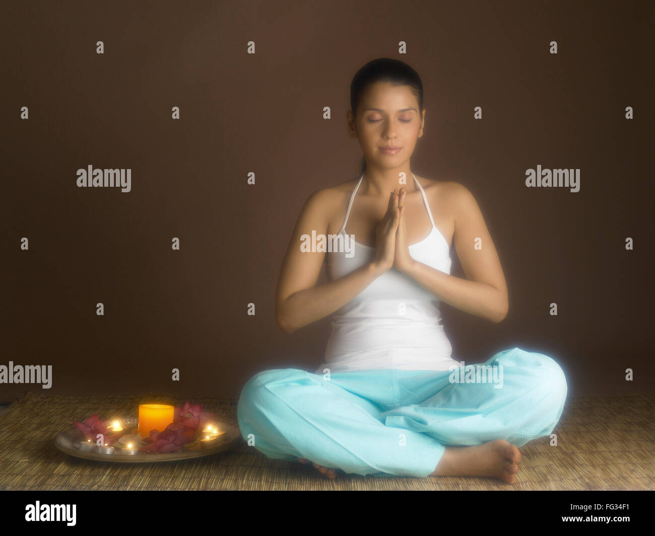 South Asian Indian woman praying with prayer utensil MR # 702 Stock Photo