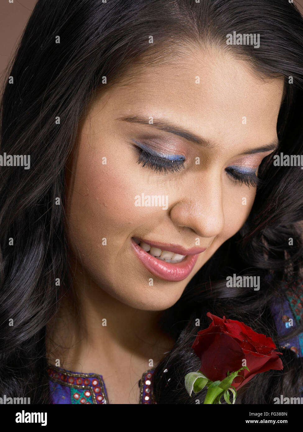 South Asian Indian woman smiling and holding red rose MR # 702 Stock ...