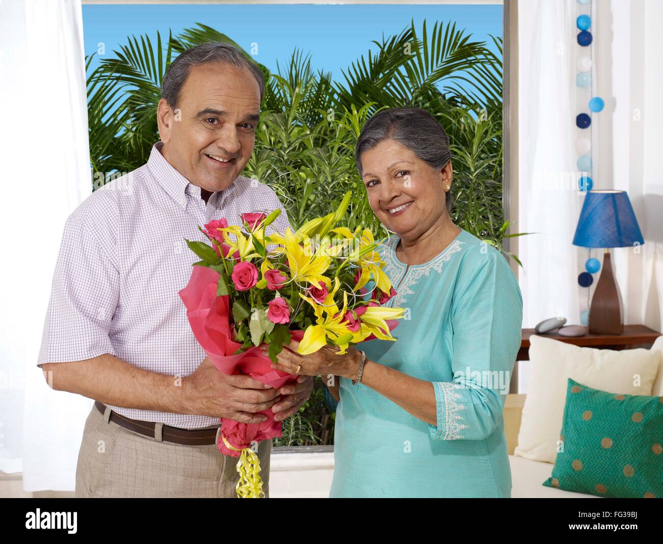 Old couple holding bouquet looking at camera MR#702T, 702S Stock Photo