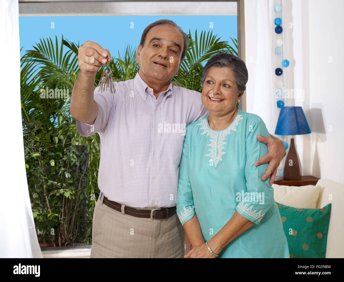 Old couple embracing showing bunch of key MR#702T, 702S Stock Photo