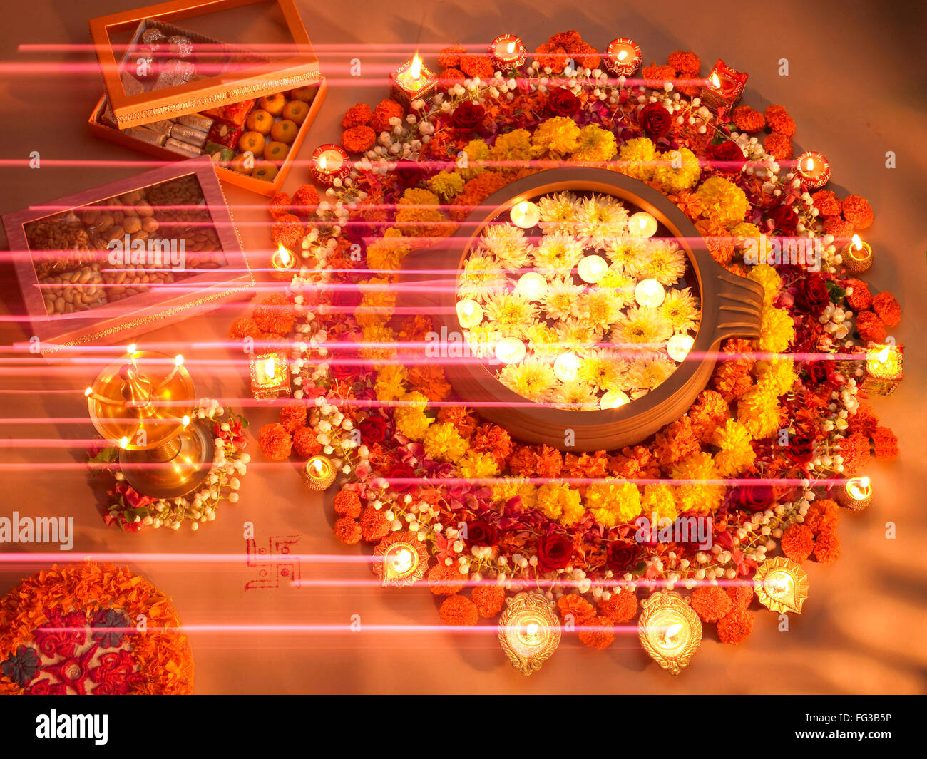Diyas and flowers arrangement for Diwali festival of lights Stock Photo