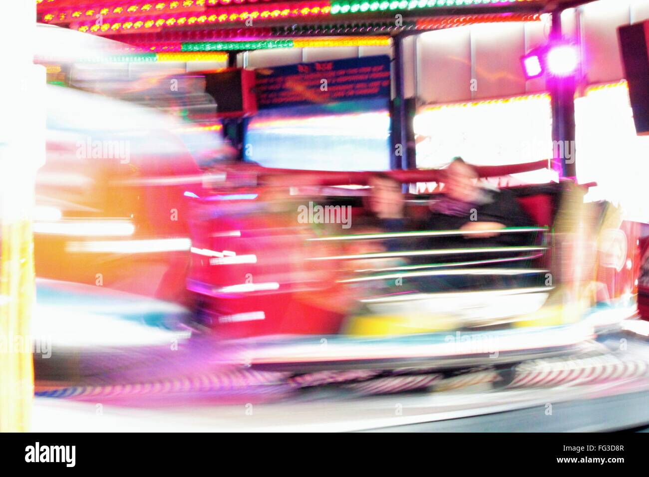 fairground funfair ride moving fast fair lights Night colours of the ...