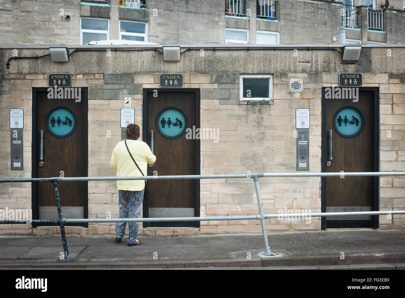 Woman about to use public toilets in Cirencester, Cotswolds Stock Photo