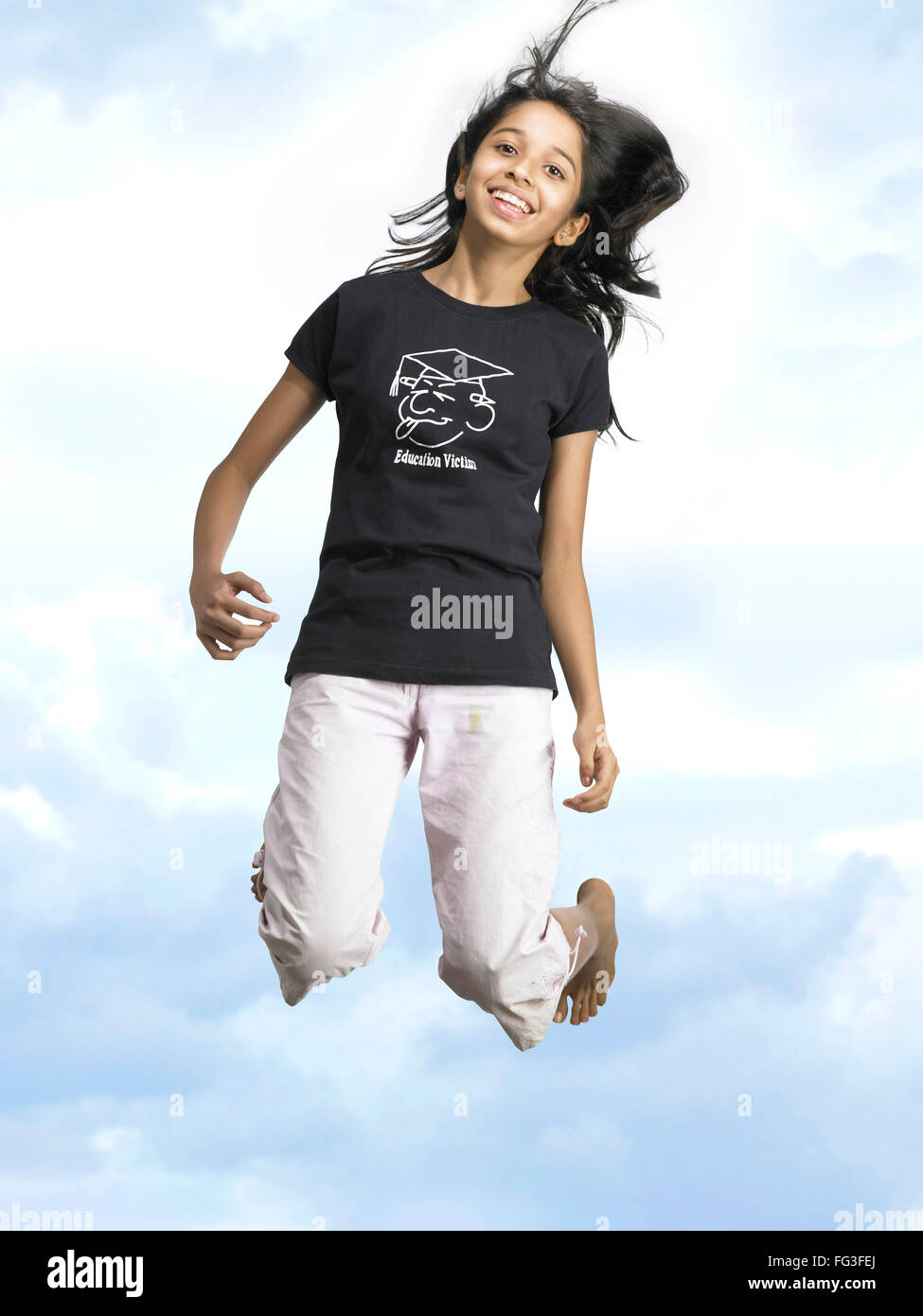 Girl jumping with joy in blue sky MR Stock Photo - Alamy