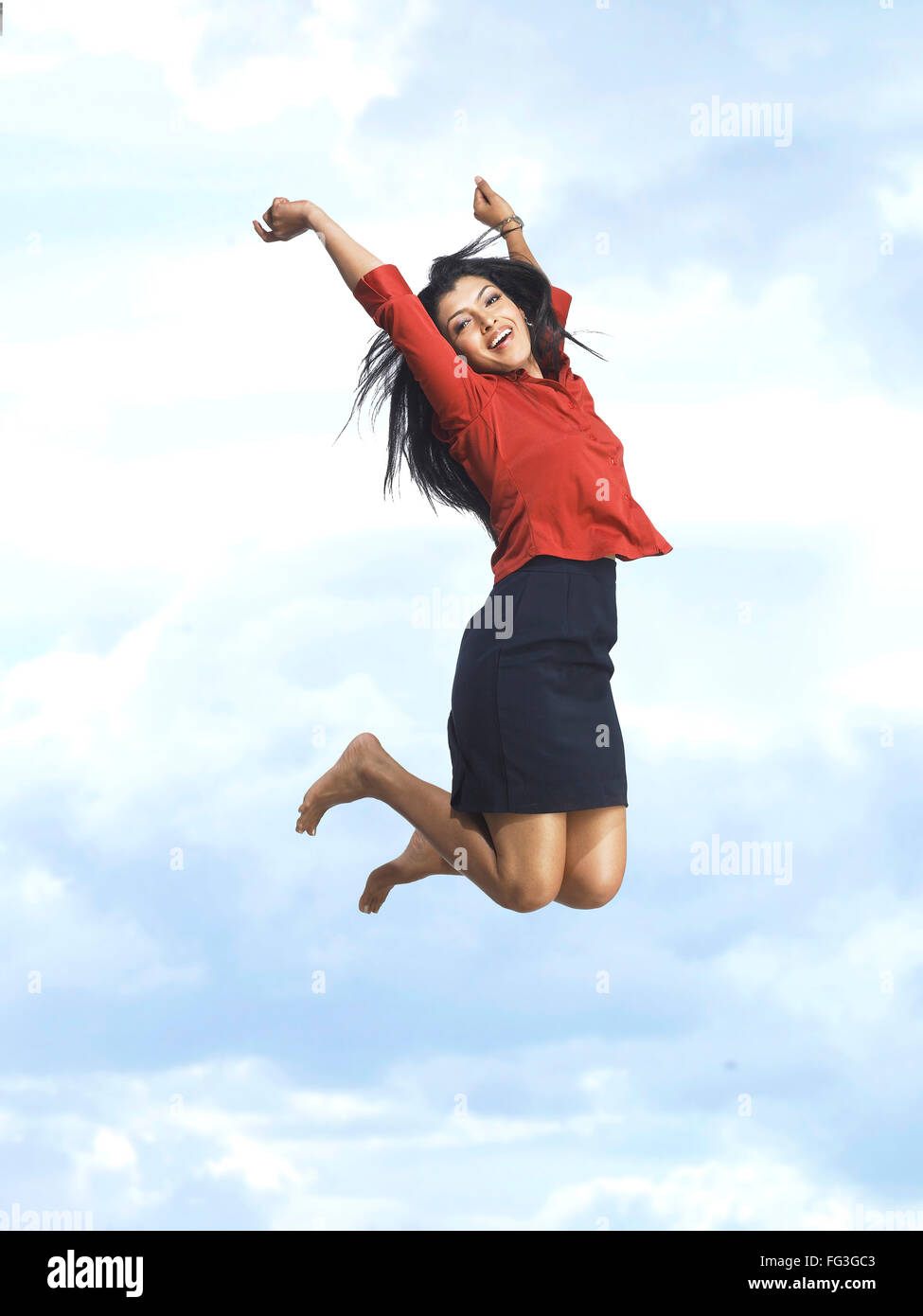 Executive jumping with joy in blue sky MR Stock Photo - Alamy