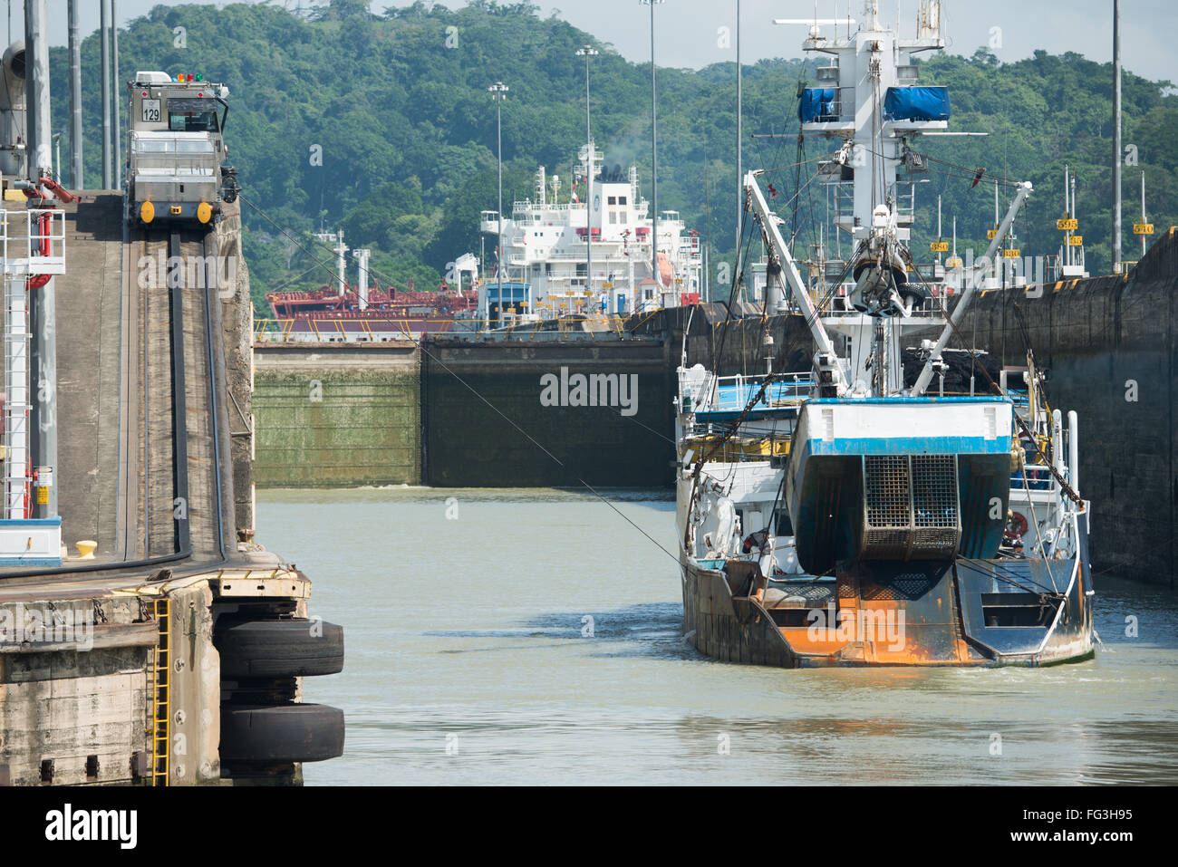 PANAMA CANAL, Panama--Opened in 1914, the Panama Canal is a crucial shipping lane between the Atlantic and Pacific Oceans that mean that ships don't have to go around the bottom of South America or over the top of Canada. The Canal was originally built and owned by the United States but was handed back to Panama in 1999. Stock Photo