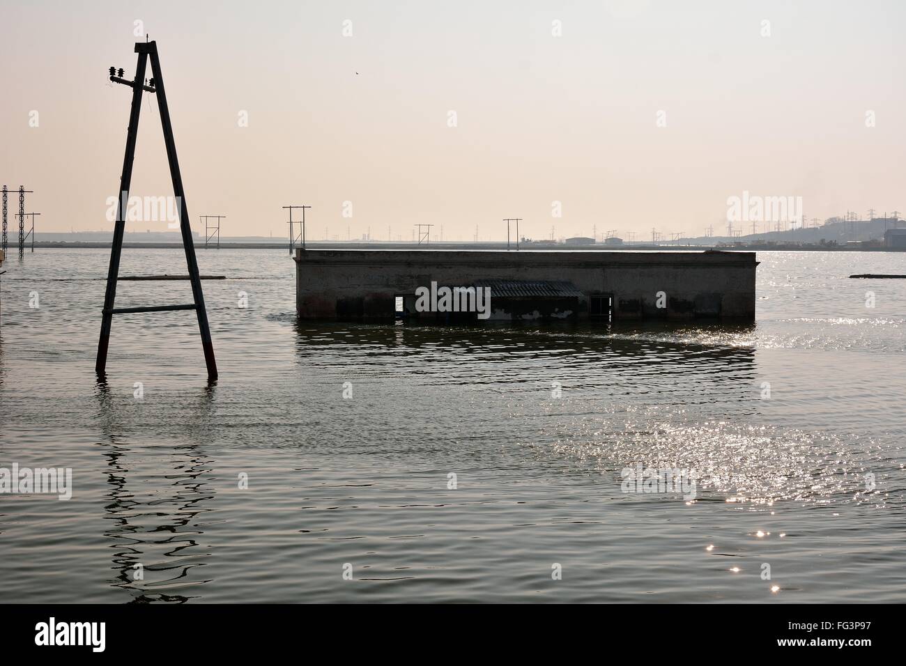 pylons-and-building-flooded-by-lake-near-lokbatan-azerbaijan-a