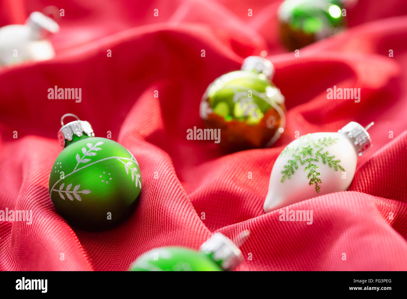 Christmas baubles on red textile Stock Photo