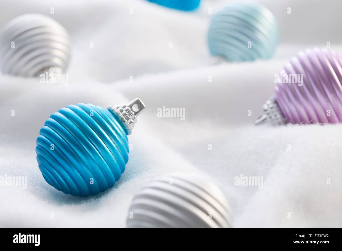 Christmas baubles on white textile Stock Photo