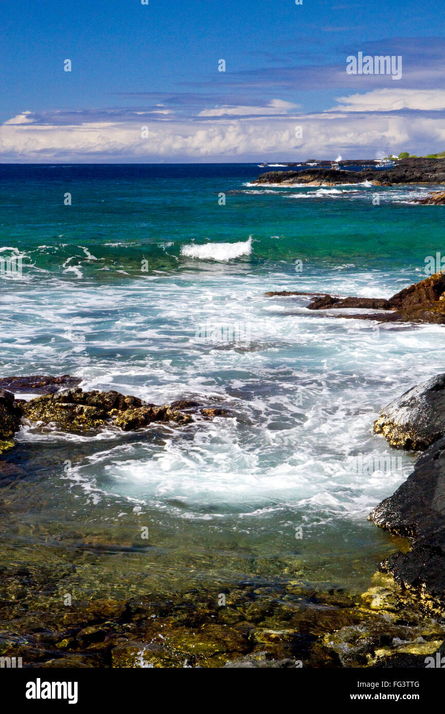 Waves crash along the rocky coast at Kailua-Kona on the Big Island of Hawaii, USA. Stock Photo