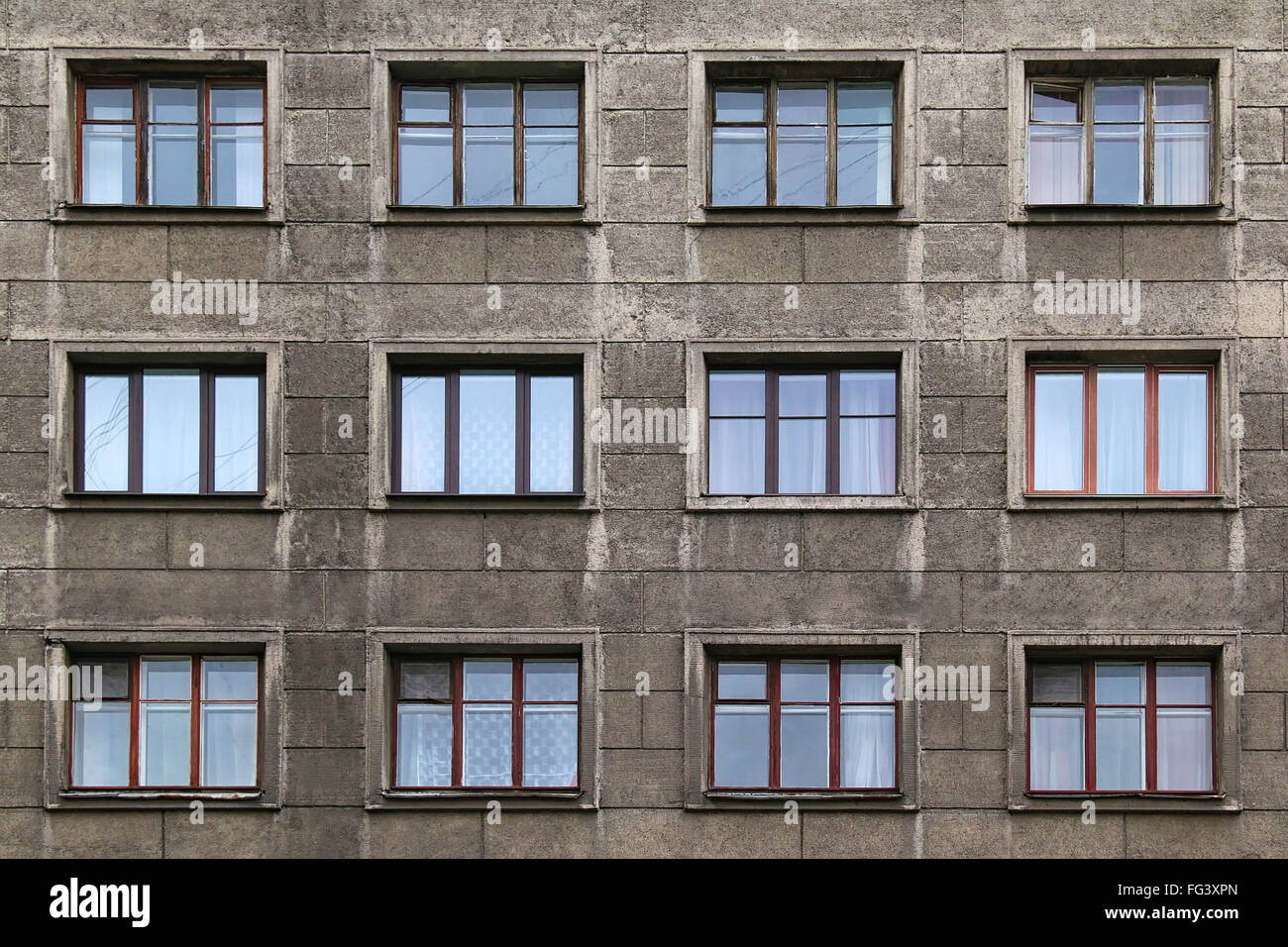 Many windows in row on facade of urban apartment building front view, St. Petersburg, Russia Stock Photo