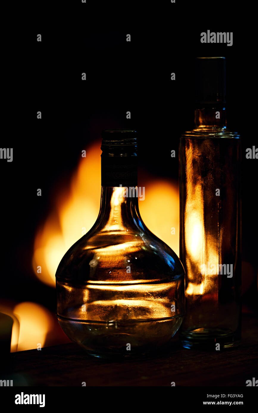 Two transparent glass bottles in front of a fire Stock Photo Alamy