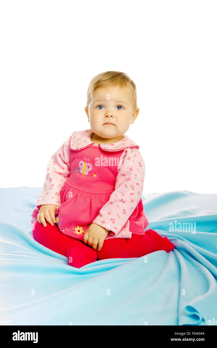 Little girl baby in a dress sitting on the floor Stock Photo - Alamy