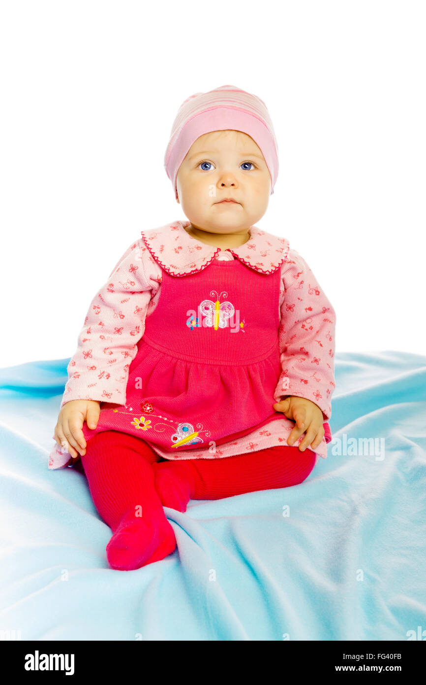 Little girl baby in a dress sitting on the floor Stock Photo - Alamy