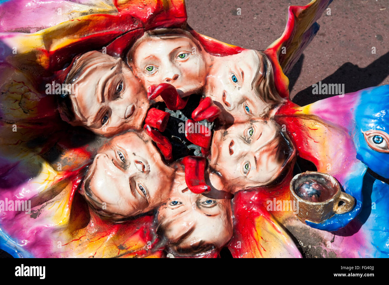 Bizarre sculpture of heads with long red tongues at the Prater amusement park in Vienna Stock Photo